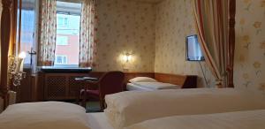 Postel nebo postele na pokoji v ubytování Hotel Hohenstauffen