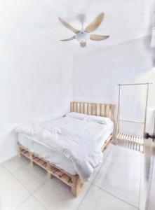 a white bedroom with a bed and a ceiling fan at One Life Four Season Waterpark Guest House Manhattan Condominium in Ipoh
