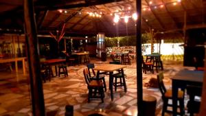 a group of tables and chairs under a tent at PosadaManduka Eco-Hostel in Villavicencio