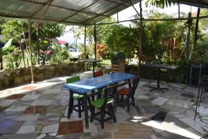a blue table and chairs under a tent at PosadaManduka Eco-Hostel in Villavicencio