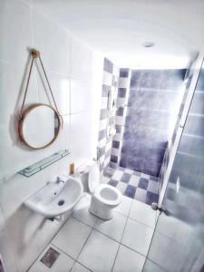 a bathroom with a toilet and a sink and a shower at One Life Four Season Waterpark Guest House Manhattan Condominium in Ipoh