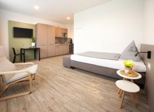 a bedroom with a bed and a table and chairs at boardinghouse Main-Tauber in Tauberbischofsheim