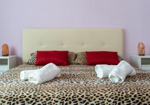 a large bed with three pillows on top of it at B&B Diana in Marostica