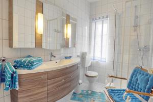 a bathroom with a sink and a toilet and a mirror at Seerano in Zingst