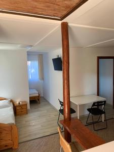 Cette chambre comprend un lit, un bureau et une table. dans l'établissement Mineral apartman Crystal, à Sóstófürdő