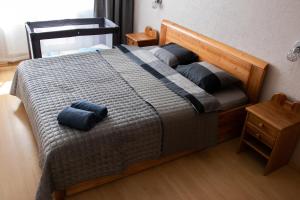 a bedroom with a bed with two pillows on it at Apartament Amber, Liepāja in Liepāja
