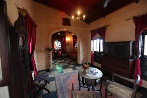a living room with a table and chairs in a room at Emerson on Hurumzi in Zanzibar City