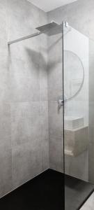 a shower with a glass door in a bathroom at Bergblick Apartment in Zentrumsnähe mit Garage in Merano