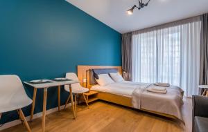 une chambre avec un lit et un mur bleu dans l'établissement B&H2, à Goudaouri