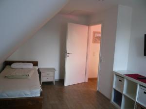 a small bedroom with a bed and a closet at Aloha 1 in Neue Tiefe Fehmarn