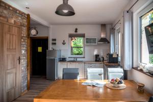 a kitchen with a table with a bowl of fruit on it at Dom Morski in Lubiatowo