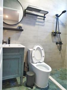a bathroom with a toilet and a sink and a mirror at 星空後苑 in Xiaoliuqiu