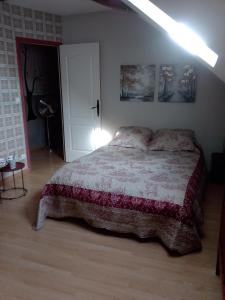 a bedroom with a bed and a lamp in it at La longère in Épineu-le-Chevreuil