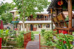 a house with a staircase leading to a garden at HEYUAN in Chiang Mai