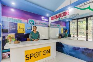 a woman standing at a counter in a room at Ijen Traveller & Homestay in Banyuwangi