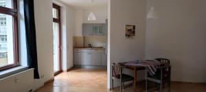 - une cuisine avec une table et des chaises dans la chambre dans l'établissement Apartment Dresden City Centre, à Dresde