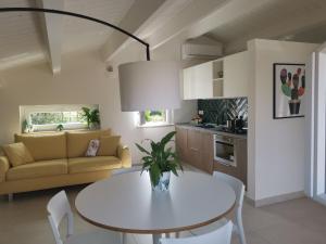 a living room with a white table and a couch at Una fuga inaspettata in Castellabate +49 photos