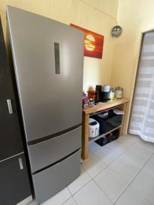 a kitchen with a refrigerator and a table at Appartement au centre de Nice in Nice +13 photos