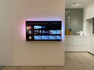 a wall mounted television on a wall in a kitchen at White Goose in Ivano-Frankivsk