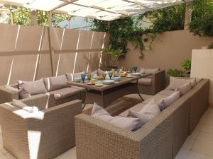 patio con sedie in vimini e tavolo con cibo di Nikoleta Apartment a Chania