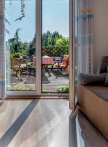 a living room with a sliding glass door at Dom Morski in Lubiatowo +29 photos