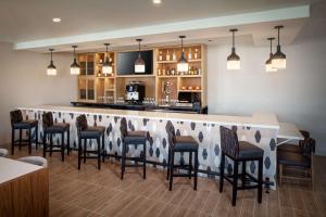 a bar in a restaurant with chairs around it at Hyatt House North Scottsdale in Scottsdale