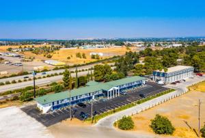 an aerial view of a building with a parking lot at Days Inn by Wyndham Red Bluff in Red Bluff