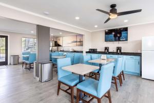 a dining room with blue chairs and tables at Days Inn by Wyndham Red Bluff in Red Bluff