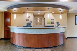 a large lobby with a bar in a hotel at Comfort Suites Little Rock in Little Rock