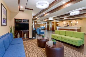 a lobby with couches and a flat screen tv at Comfort Suites Little Rock in Little Rock