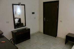 a bathroom with a mirror and a door at Monte Cairo Serviced Apartments in Cairo