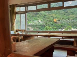 a room with wooden benches and a large window at Liwu Hotel Taroko in Fushi