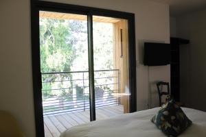 a bedroom with a bed and a large sliding glass door at Bread et Couette in Lyon