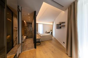 a hallway with a living room and a bedroom at PALAZZO RAHO SUITES in Cefalù