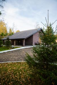 a house with a tree in front of it at Grand Hotel & Spa Aristokrat Kostroma in Kostroma