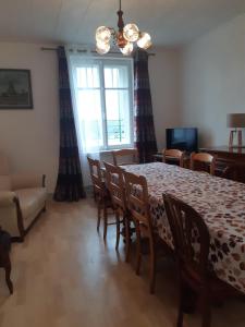 een eetkamer met een tafel, stoelen en een bank bij Gîte La Fabrique bain nordique & sauna , raquettes des neiges in Les Fontenelles +16 foto's