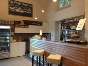 a bar in a restaurant with stools and a counter at Panperduto in Somma Lombardo