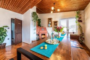 a large wooden table in a living room with a fireplace at U deda a starkej in Čierny Blh