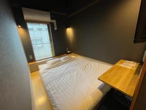 Postel nebo postele na pokoji v ubytování Yumoto Station Hotel MIRAHAKONE