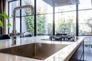 a kitchen with a sink and a counter top at Luxe Suites Roses in Amsterdam