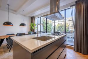 a large kitchen with a large window at Luxe Suites Roses in Amsterdam