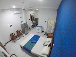 a bedroom with a large bed and chairs in it at Villa Girilena in Hikkaduwa