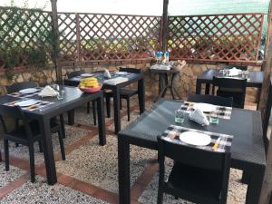 a group of tables and chairs on a patio at Busalacchi B&B in Mondello