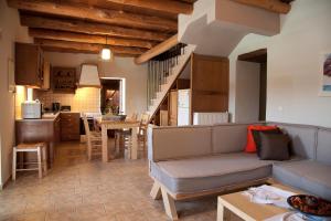 a living room with a couch and a kitchen at Citrea Villa in Fournés