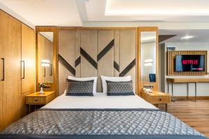 a bedroom with a large bed with a wooden headboard at Endican Sultanahmet Hotel in Istanbul