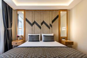 a bedroom with a large bed with a wooden headboard at Endican Sultanahmet Hotel in Istanbul