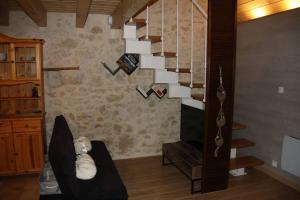 a living room with a chair and a staircase at Le Portougais, chalet à Chanaz, la petite Venise savoyarde in Chanaz
