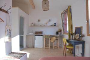 a kitchen with a refrigerator and a table at Le Bivouac - Toulouse in Toulouse