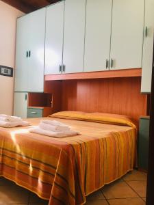 two beds in a room with white cabinets at Michelangelo Holiday & Family Resort in Lido di Spina