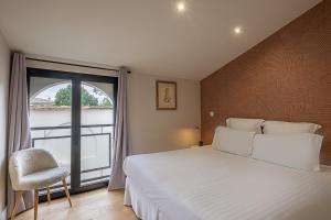Ένα ή περισσότερα κρεβάτια σε δωμάτιο στο Appartements Emile Fourcand